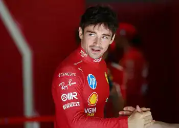 BUDAPEST, HUNGARY - AUGUST 02: Charles Leclerc of Monaco and Scuderia Ferrari greets a teammate in the garage during final practice ahead of the F1 Grand Prix of Hungary at Hungaroring on August 02, 2025 in Budapest, Hungary. (Photo by Mark Thompson/Getty Images)