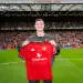 MANCHESTER, ENGLAND - AUGUST 9:   New Manchester United signing Benjamin Sesko poses with a team shirt prior to the pre-season friendly match between Manchester United and ACF Fiorentina at Old Trafford on August 9, 2025 in Manchester, England. (Photo by Ash Donelon/Manchester United via Getty Images)