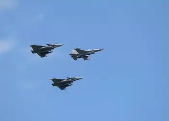 A Polish air force F-16 is flanked on either side by Dassault Rafale fighter jets as they perform a flyover during the National Army Day military parade in Warsaw, Poland, on August 15, 2025. Thousands of members of the Polish armed forces take part in the Armed Forces Day military parade that takes place annually on August 15 to commemorate Poland's victory over the Soviet Union's army in 1920. (Photo by Aleksander Kalka/NurPhoto via Getty Images)