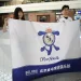 Real Madrid fans from China, Rebecca Feng (L) and Alex Lee pose with a banner at the Beijing Daxing International Airport in Beijing on September 29, 2025, before boarding a flight to Kazakhstan, to watch the football team play in the Champions League. The Spanish giants are playing local minnows Kairat in Kazakhstan's biggest city Almaty on September 30, a game sports magazine The Athletic called "arguably the biggest mismatch in the competition's history". But for Asian Real Madrid fans, it's a rare opportunity to see their idols without having to travel 7,000 kilometres or more to Europe. (Photo by GREG BAKER / AFP)