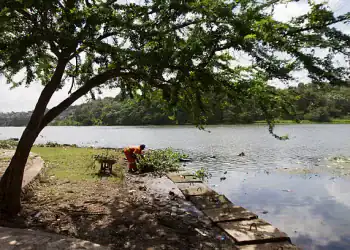 A man picks up trash from the shore of the river Osama at the beginning of the rainy season in Dominican Republic on May 31, 2012 in Santo Domingo. Dominican people take the necessary measures to prepare for the 2012 Atlantic hurricane season that begins officialy on June 1 and ends on November 30.   AFP PHOTO / ERIKA SANTELICES        (Photo credit should read ERIKA SANTELICES/AFP/GettyImages)