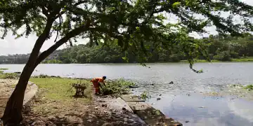 A man picks up trash from the shore of the river Osama at the beginning of the rainy season in Dominican Republic on May 31, 2012 in Santo Domingo. Dominican people take the necessary measures to prepare for the 2012 Atlantic hurricane season that begins officialy on June 1 and ends on November 30.   AFP PHOTO / ERIKA SANTELICES        (Photo credit should read ERIKA SANTELICES/AFP/GettyImages)
