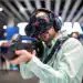 In Barcelona, Spain, on February 26, 2024, a man is playing an immersive game using the virtual reality equipment HTC Vive during his visit to the Mobile World Congress. (Photo by Charlie Perez/NurPhoto via Getty Images)