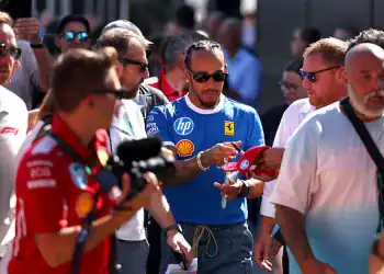 MONZA, ITALY - SEPTEMBER 06: Lewis Hamilton of Great Britain and Scuderia Ferrari signs autographs for fans prior to final practice ahead of the F1 Grand Prix of Italy at Autodromo Nazionale Monza on September 06, 2025 in Monza, Italy. (Photo by Clive Rose/Getty Images)