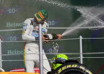 McLaren driver Lando Norris (white uniform) takes first place in the Mexican Grand Prix at the Autodromo Hnos. Rodriguez in Mexico City, Mexico, on October 26, 2025, where Ferrari's Charles Leclerc finishes second, and Red Bull's Max Verstappen finishes third. (Photo by Gerardo Vieyra/NurPhoto via Getty Images)