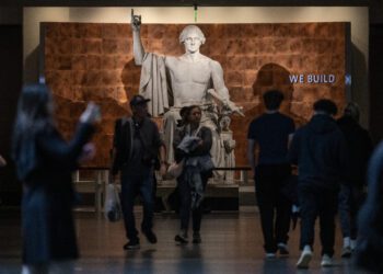 Visitors walk through the American History museum on the first day of the Smithson museum openings after the US Government reopened on the National Mall in Washington, DC on November 14, 2025. After 43 days, the waiting came to an end on November 14, 2025, when President Donald Trump signed a bill funding the government through January -- the result of a deal brokered by Republicans and a handful of moderate Democratic lawmakers. (Photo by ANDREW CABALLERO-REYNOLDS / AFP)