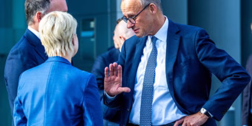 04 November 2025, Mecklenburg-Western Pomerania, Schwerin: Federal Chancellor Friedrich Merz (r, CDU) talks to Manuela Schwesig (SPD), Minister President of Mecklenburg-Vorpommern, and Simon Michel, CEO of Ypsomed, after a visit to Ypsomed. Ypsomed has been producing in Schwerin with 500 employees since August 2019 and plans to significantly increase production figures and double the number of employees in the coming years. Merz had previously attended a cabinet meeting of the state government during his inaugural visit to Mecklenburg-Vorpommern. Photo: Jens Büttner/dpa (Photo by Jens Büttner/picture alliance via Getty Images)