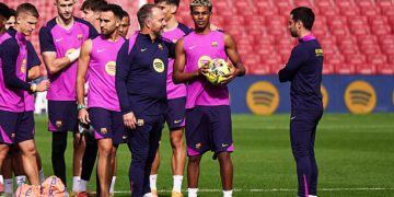 BARCELONA, SPAIN - NOVEMBER 07: Hansi Flick, Manager of FC Barcelona, talks with Lamine Yamal of FC Barcelona at the end of an open training session at Spotify Camp Nou on November 07, 2025 in Barcelona, Spain. (Photo by Manuel Queimadelos/Quality Sport Images/Getty Images)