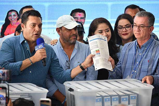 Honduras' Mayoral candidate for Tegucigalpa for the ruling Libertad y Refoundation (LIBRE) party, Juan Diego Zelaya (L), speaks as votes are counted in Tegucigalpa, on December 4, 2025. Right-wing businessman Nasry Asfura, supported by US President Donald Trump, regained the lead in the Honduran presidential election count on Thursday, although he remains in a technical tie with television presenter Salvador Nasralla. (Photo by Orlando SIERRA / AFP via Getty Images)