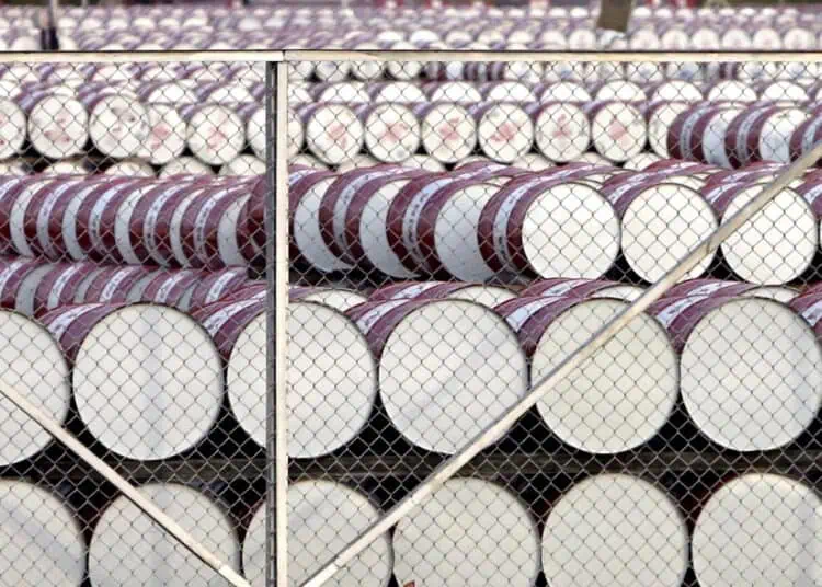 Barriles de petróleo y gráficos de precios al alza sobre el mercado del crudo Brent