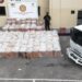 Agentes del Ceccom junto a tanques de gasoil y cajas de cigarrillos decomisados en operativo del MICM en República Dominicana
