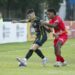 Jugadores de Moca FC y Atlético Vega Real disputando el balón en el estadio Moca 85 durante el partido inaugural de la LDF 2026-2027