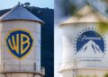 Logotipos de Warner Bros Discovery y Paramount Skydance en pantallas durante anuncio de fusión corporativa