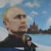 A serviceman of Russia's Emergencies Ministry sits under a mural depicting Russian President Vladimir Putin during Russia's parliamentary election at a polling station in Donetsk, Russian-controlled Ukraine, on September 20, 2026, amid the ongoing Russian-Ukrainian conflict. (Photo by AFP)