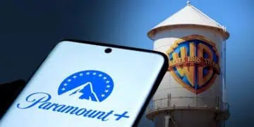 Logos de Paramount y Warner Bros. Discovery en pantallas frente a edificios corporativos en Estados Unidos