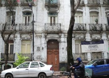 Familia mexicana en una vivienda de autoconstrucción revisando sus finanzas personales en la mesa