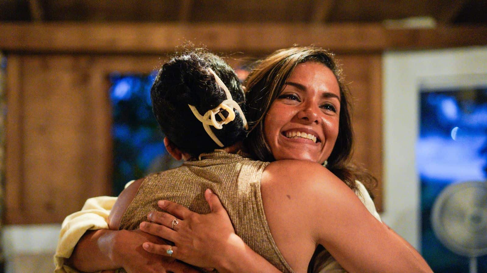 Dos personas se abrazan sonrientes en un evento del PLD.