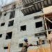 Obras de construcción de viviendas en República Dominicana con materiales apilados en primer plano