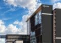 Fachada de hospital moderno en Chihuahua con pacientes internacionales y zona de servicios médicos especializados