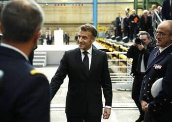 France's President Emmanuel Macron (C) greets French Navy members after delivering a speech next to nuclear-powered ballistic missile submarine (SSBN) submarine "Le Temeraire" - S617 during his visit to the Nuclear Submarine Navy Base of Ile Longue in Crozon, north-western France on March 2, 2026. High expectations, few certainties: on March 2, 2026, Emmanuel Macron is set to outline how France's nuclear deterrent can help strengthen security in Europe in the face of a increasingly brutal world and an increasingly uncertain US ally. This issue has been brought sharply into focus by the Israeli-US offensive in Iran this weekend, against the backdrop of the Iranian nuclear crisis, which is shaking the entire Middle East and, by extension, the international community. (Photo by Yoan VALAT / POOL / AFP via Getty Images)