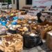 Agentes del Ceccom junto a cajas de cigarros premium y botellas de mamajuana incautadas en Higüey, provincia La Altagracia