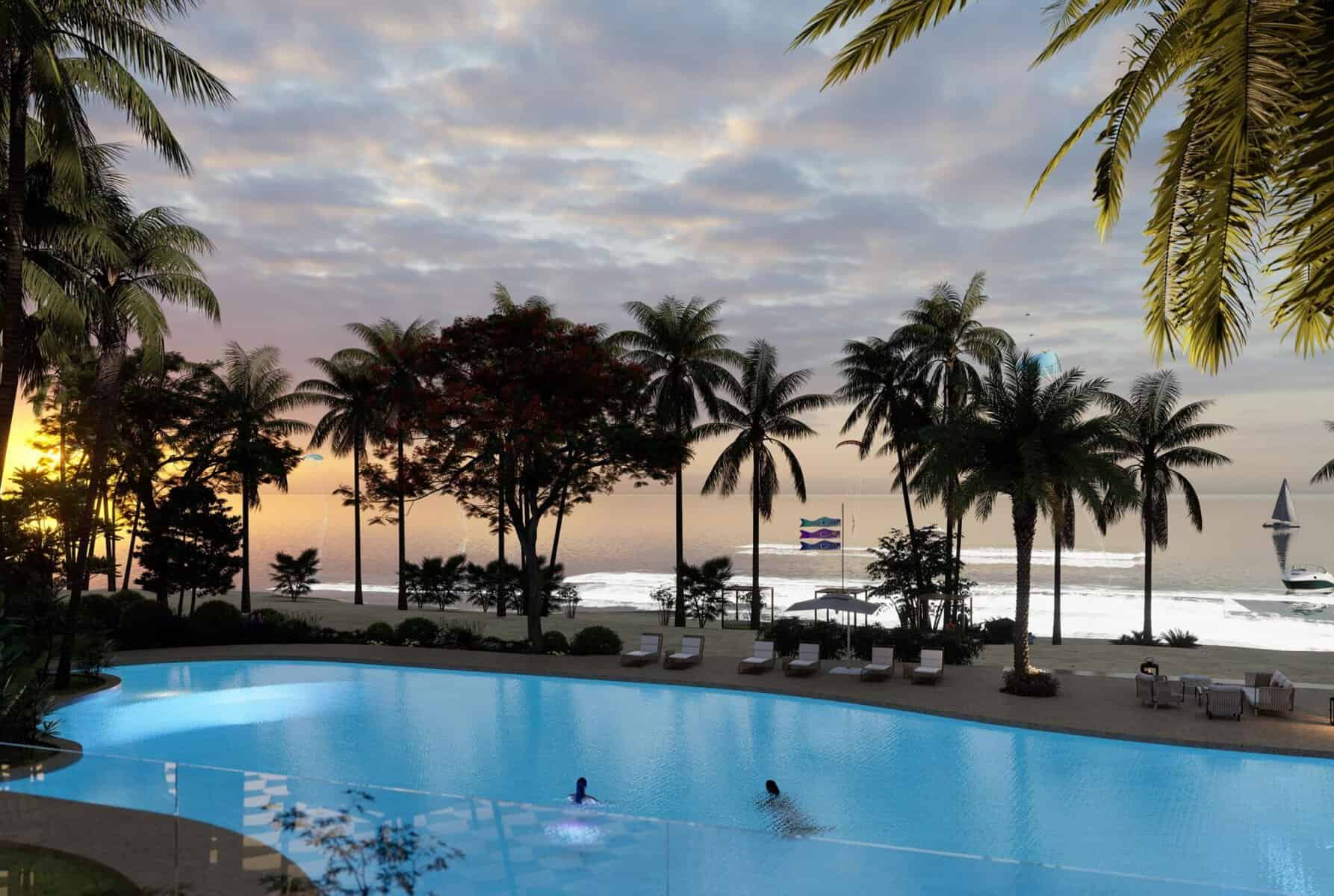 Piscina iluminada frente al mar al atardecer con palmeras y tumbonas en un resort costero.